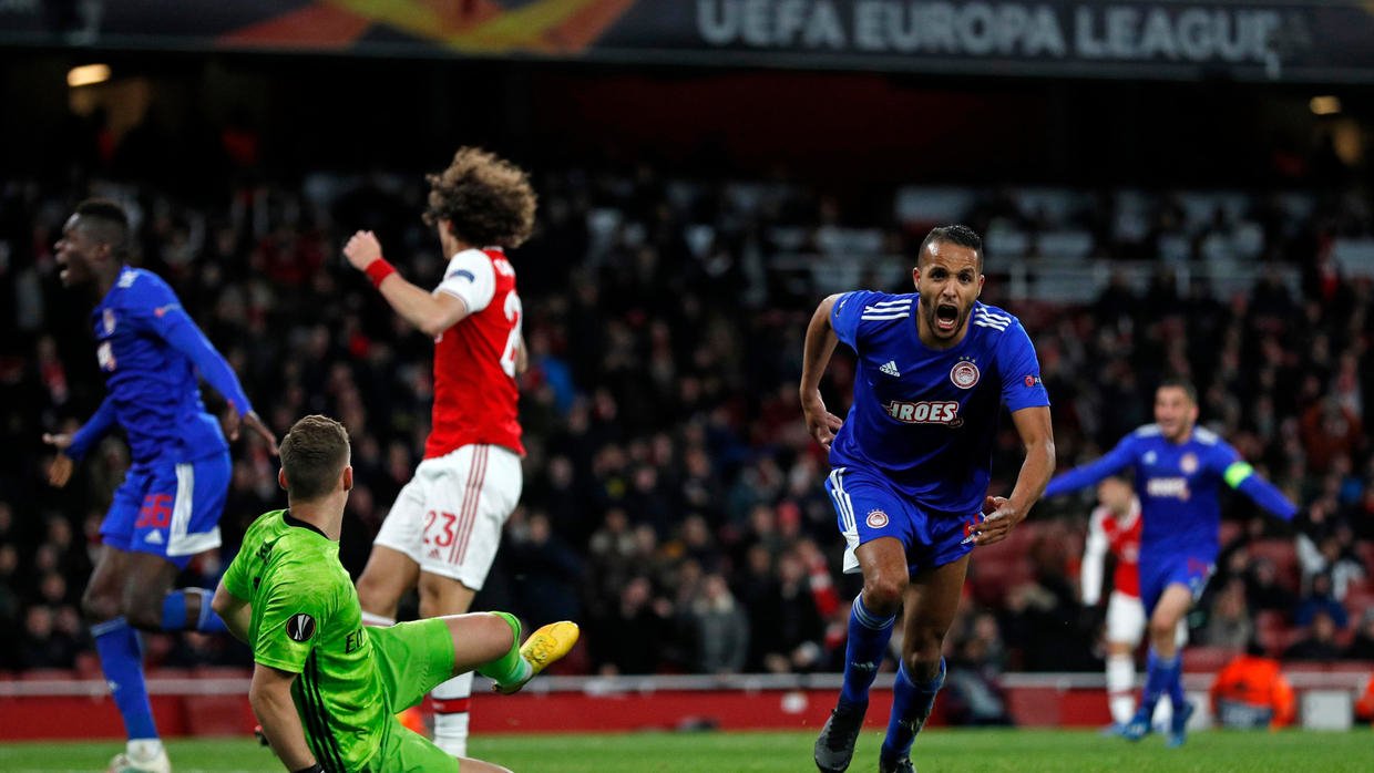 youssef el arabi scored in the last minute of extra time as olympiakos knocked arsenal out of the europa league on thursday on a night when four former european champions were eliminated photo afp
