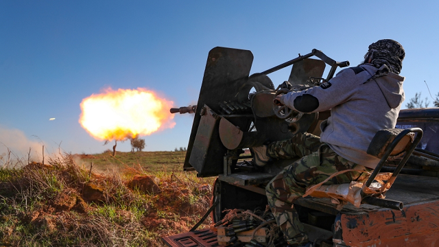 a turkey backed syrian fighter fires a truck mounted gun towards the town of saraqeb photo afp