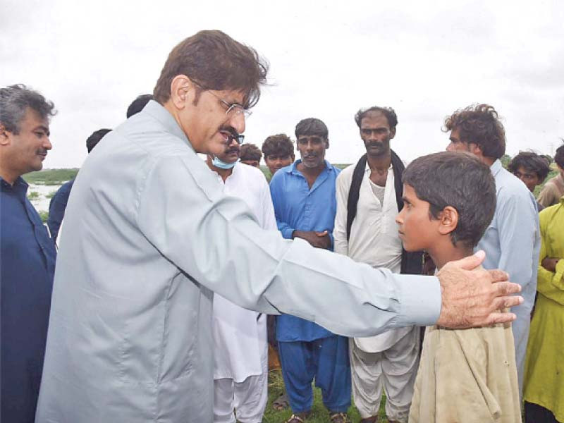 sindh chief minister syed murad ali shah reassures a child at a camp set up at dooleh darya photo express