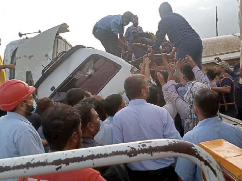 people pull out injured passenger of a van which collided with an 18 wheeler oil tanker on the national highway near the pakistan steel mills on monday photo ppi