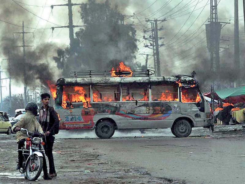 a bus burns during clash between two groups of transporters photo app