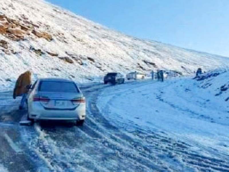 motorists travel on babusar top which saw the first snowfall of the winter photo express