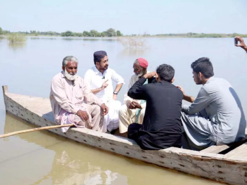 sindh assembly opposition leader haleem adil sheikh interacts with people on a boat in the flood hit tando allahyar district photo ppi sindh assembly opposition leader haleem adil sheikh interacts with people on a boat in the flood hit tando allahyar district photo ppi