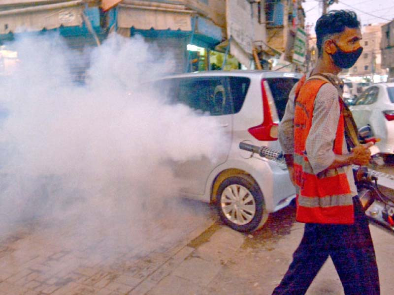 a workers carries out anti mosquito spray in a market amid rising cases of dengue and malaria photo jalal qureshi express
