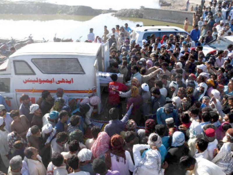 people come to receive the bodies of the nooriabad bus fire victims at their ancestral village in khairpur nathan shah photo express