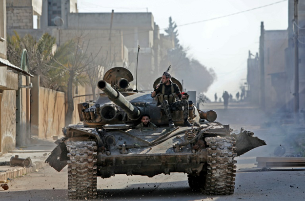 a rebel tank patrols the streets of saraqeb reduced to a ghost town abandoned by its residents after weeks of fighting photo afp