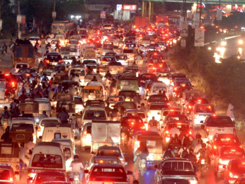 commuters are caught in a traffic jam on shahrae faisal due to a protest of the pti workers against the attack on imran khan photo express