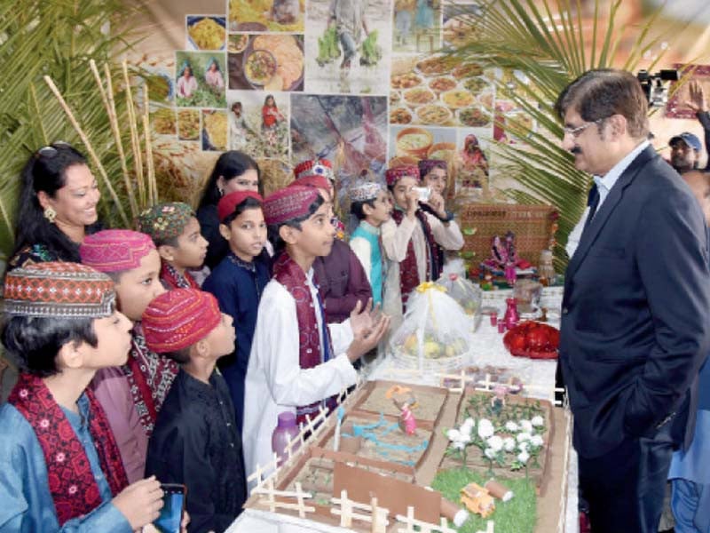 chief minister syed murad ali shah talks to students at their stalls they organised in connection with the sindh cultural day at the st paul s school photo ppi