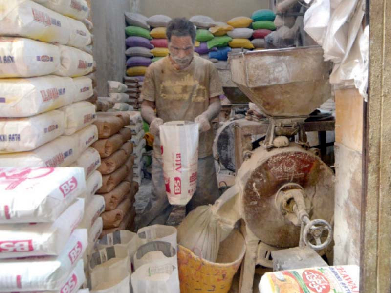 a worker grinds wheat at a shop in the saddar area of karachi to make whole grain flour photo jalal qureshi express