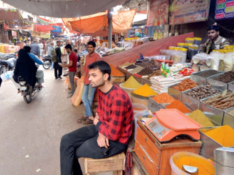 a salesman sits idle in jodia bazaar the wholesale market of pulses grains and spices shopkeepers say sales are dropping as prices continue to climb upwards photo express
