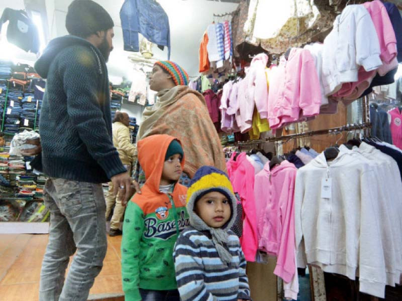 people wearing warm clothes look for more winter dresses in a saddar market photo jalal qureshi express
