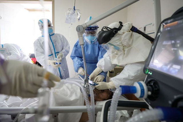 medical staff treat a patient infected by the coronavirus at the red cross hospital in wuhan on march 1 2020 photo afp