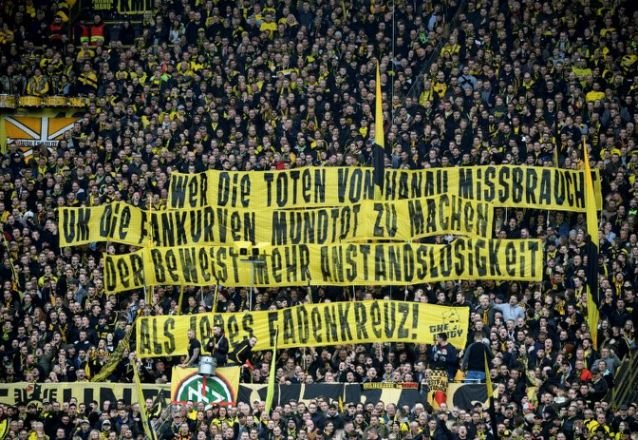 stadium announcers in dortmund and berlin threatened calling the games off unless the banners were removed photo afp