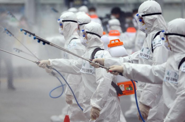 south korean soldiers wearing protective gear spray disinfectant as part of preventive measures against the spread of the covid 19 coronavirus at dongdaegu railway station in daegu on february 29 2020 photo afp south korean soldiers wearing protective gear spray disinfectant as part of preventive measures against the spread of the covid 19 coronavirus at dongdaegu railway station in daegu on february 29 2020 photo afp