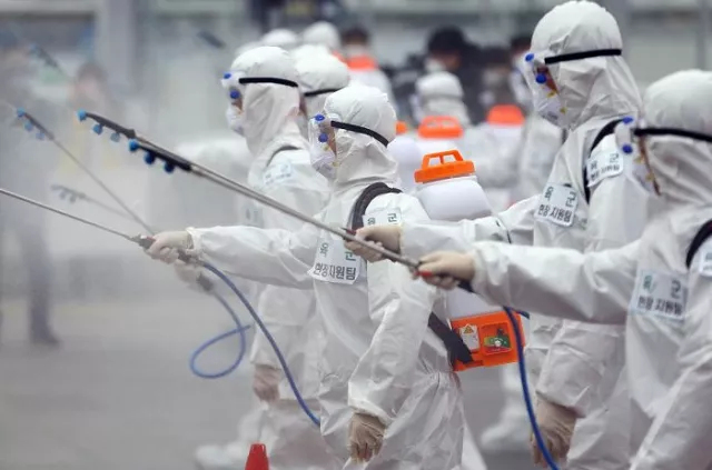 south korean soldiers wearing protective gear spray disinfectant as part of preventive measures against the spread of the covid 19 coronavirus at dongdaegu railway station in daegu on february 29 2020 photo afp south korean soldiers wearing protective gear spray disinfectant as part of preventive measures against the spread of the covid 19 coronavirus at dongdaegu railway station in daegu on february 29 2020 photo afp