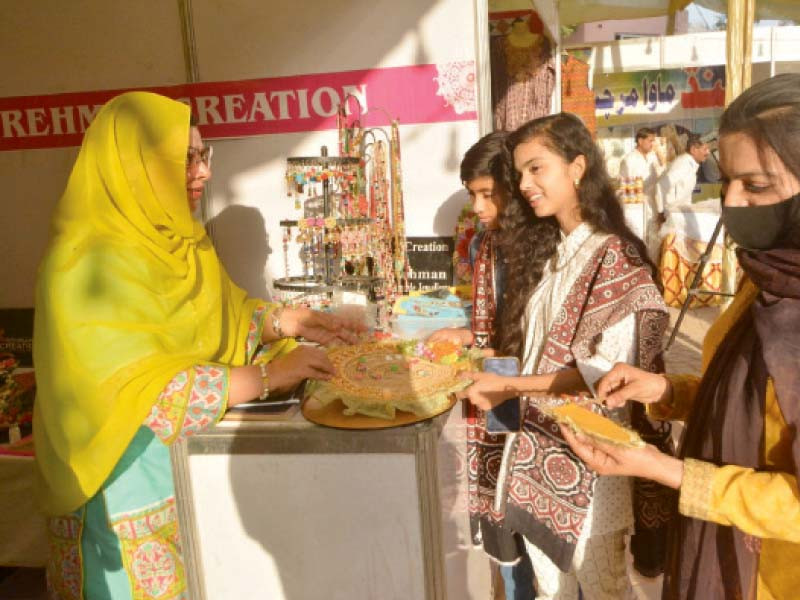 young women take interest in clothes displayed at a stall during the sindh literature festival at arts council of pakistan karachi photo express