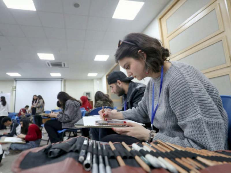 students at work during the culture festival at the ghulam ishaq khan university in swabi photo express