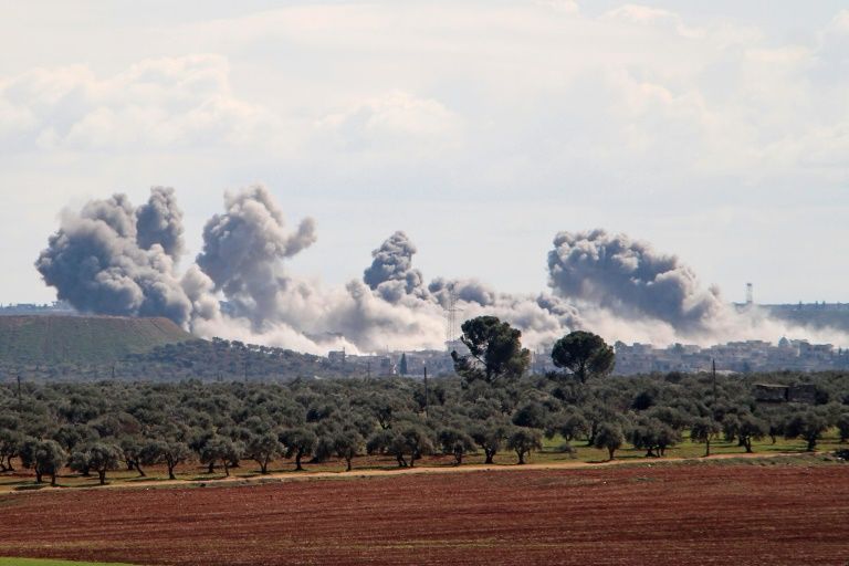 smoke billowed over the village of qaminas southeast of idlib following reported russian air strikes photo afp