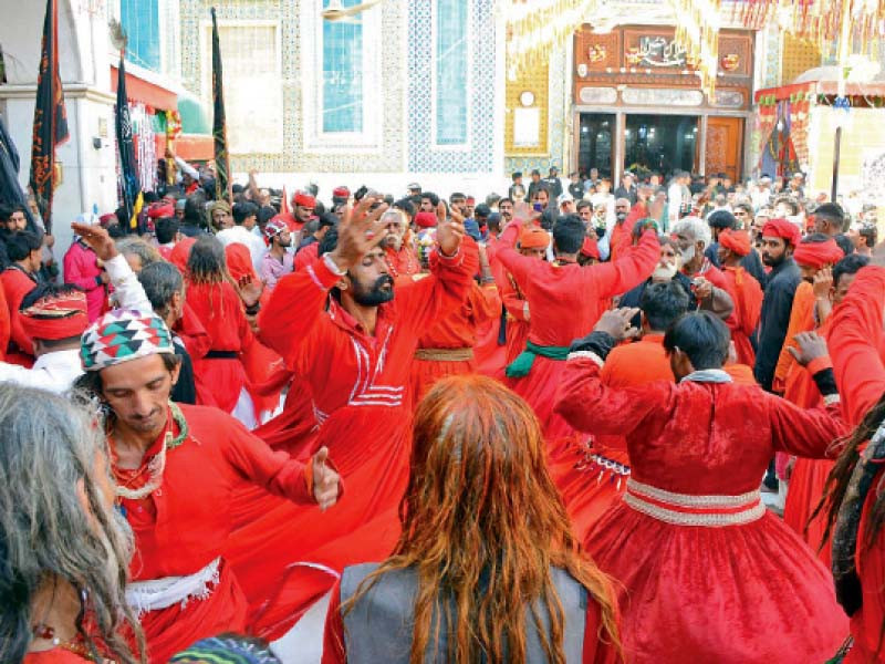 devotees perform dhammal devotional dance during the urs of lal shahbaz qalandar in sehwan on monday photos ppi