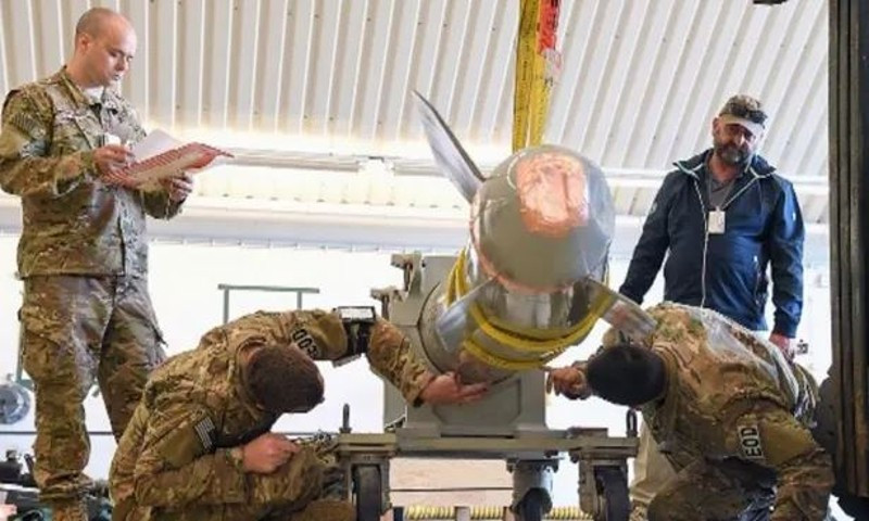 a photo in a los alamos national laboratory student briefing from 2022 shows four people inspecting what appears to be a damaged b61 nuclear bomb photo courtesy federation of american scientists