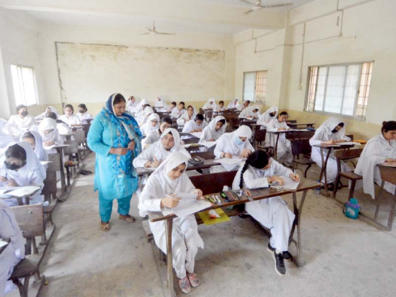 girl students solve their paper at the abdullah government college for women centre at the start of the intermediate exams on tuesday photo jalal qureshi express
