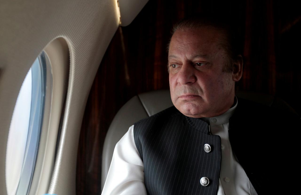 nawaz sharif looks out the window of his plan photo reuters