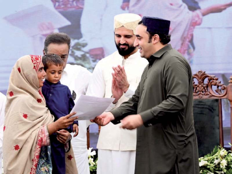 ppp chairman bilawal bhutto gives documents of a house to a flood victim in ghotki photo ppi