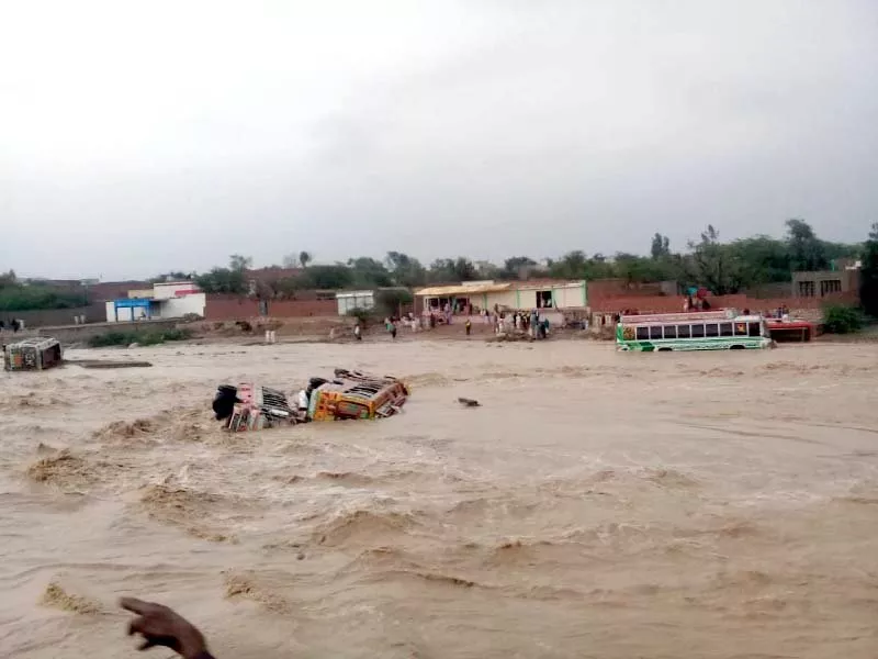 a view of buses swept away by hill torrents in dera ghazi khan photo express a view of buses swept away by hill torrents in dera ghazi khan photo express