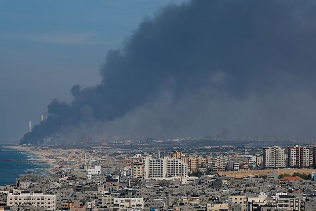 Smoke rises from the Israeli side after Palestinian Hamas gunmen infiltrated areas of southern Israel, as seen from Gaza, October 7, 2023. REUTERS