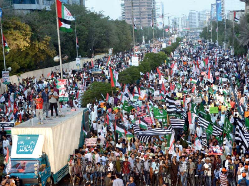 thousands of people take part in a rally organised by the mqm p on sharae faisal on friday to denounce israeli atrocities in gaza photo jalal qureshi express