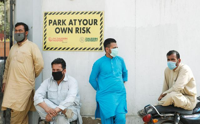 men wearing face masks wait to see their relatives who were admitted after being affected from a suspected gas leak at the hospital entrance in karachi photo reuters file men wearing face masks wait to see their relatives who were admitted after being affected from a suspected gas leak at the hospital entrance in karachi photo reuters file