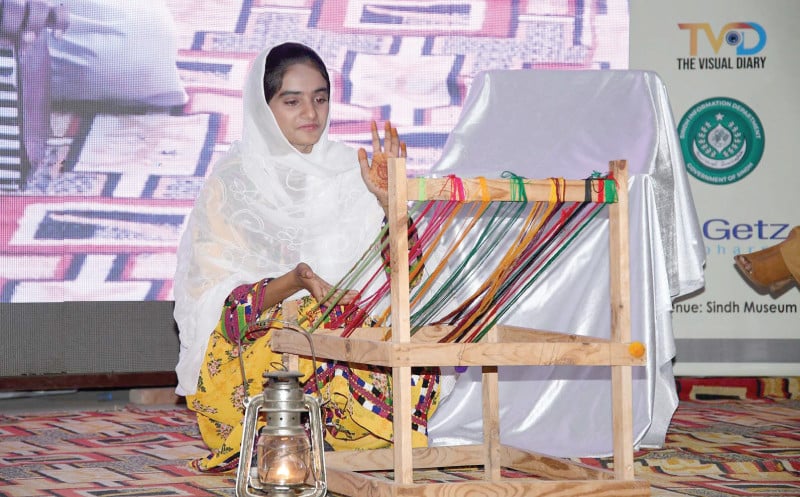 a female student performs old method of weaving during the ongoing 9th hyderabad literature festival at the sindh museum on saturday photo inp