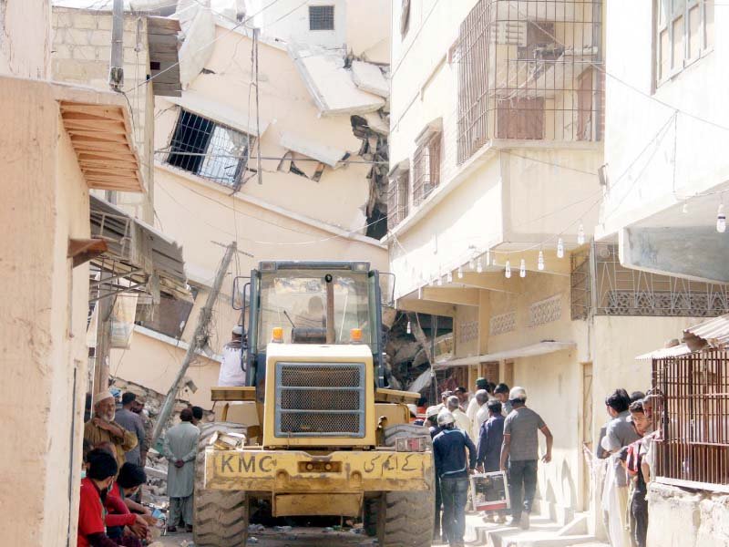 narrow streets made it difficult for excavators to reach the site of the collapse photo online