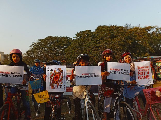 participants holding placards at the aurat march in karachi photo express