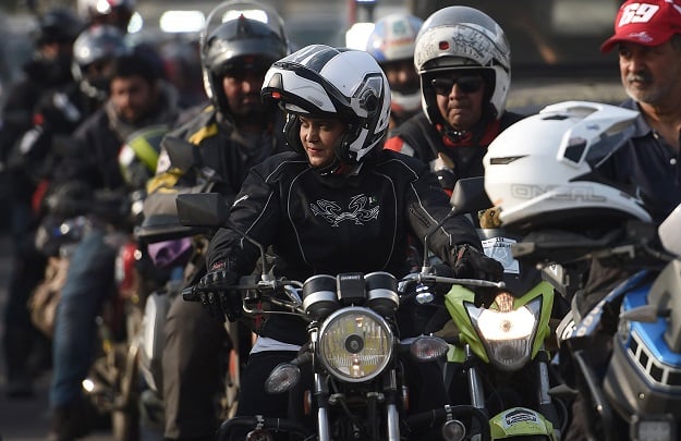 A rider participating in the Motor Rally leads bikers upon arriving in Islamabad. PHOTO: AFP