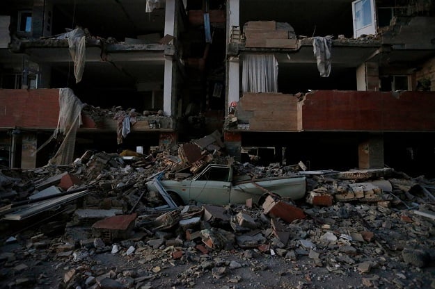  A flattened vehicle underneath building rubble is seen following a 7.3-magnitude earthquake at Sarpol-e Zahab in Iran's Kermanshah province. PHOTO: AFP