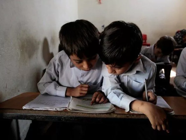 a reuters file photo showing two children studying a reuters file photo showing two children studying