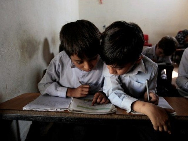 a reuters file photo showing two children studying a reuters file photo showing two children studying