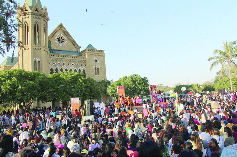 hundreds of participants attend the aurat march at frere hall holding up signs calling attention to the struggles of marginalised communities photos inp nni