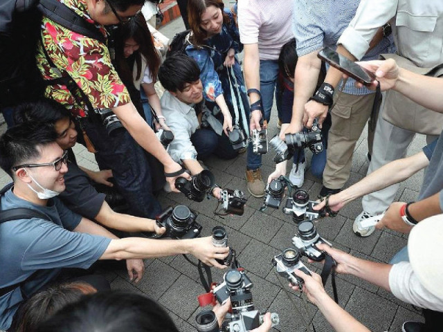 instead of pressing a smartphone button more and more young people want to experience the original act of taking a photograph photo file instead of pressing a smartphone button more and more young people want to experience the original act of taking a photograph photo file