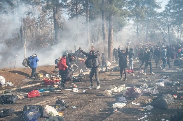 dozens of greek security officers and soldiers fired tear gas as riot police officers with batons shields and masks confronted migrants yelling at them to stay back on saturday photo afp dozens of greek security officers and soldiers fired tear gas as riot police officers with batons shields and masks confronted migrants yelling at them to stay back on saturday photo afp