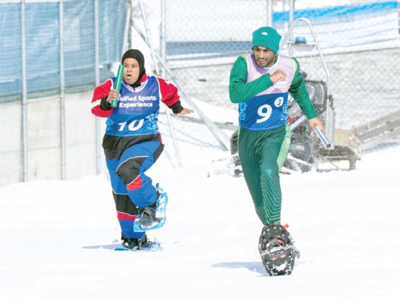 pakistan s snowshoeing athlete ali raza r participates in the unified sports experience relay race at the 12th special olympics world winter games in turin on monday photo sop