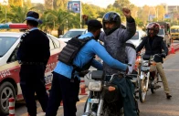 a police officer frisks a biker at a security check post along a road following yesterday s blast outside the district court building reuters a police officer frisks a biker at a security check post along a road following yesterday s blast outside the district court building reuters