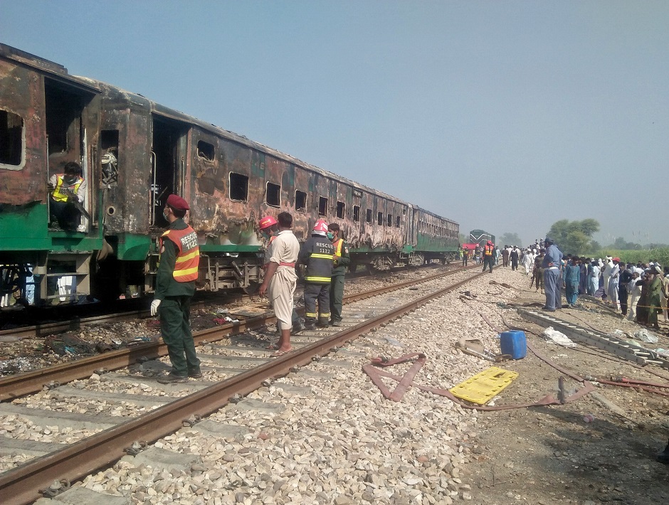 people and rescue workers gather near the site after a fire broke out in tezgam and destroyed three carriages photo reuters