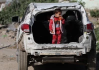 a palestinian child stands in the trunk of a damaged car near a cemetery during eid al fitr in gaza city march 20 2026 reuters