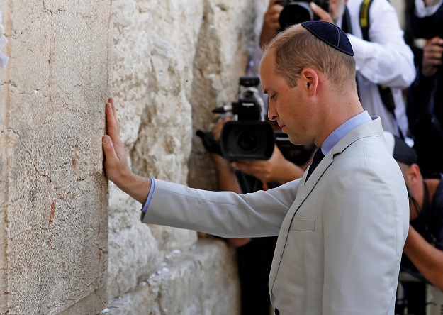 Britain's Prince William touches the Western Wall, the holiest site where Jews can pray, in Jerusalem's Old City on June 28, 2018. The Duke of Cambridge is the first member of the royal family to make an official visit to the Jewish state and the Palestinian territories. PHOTO: AFP