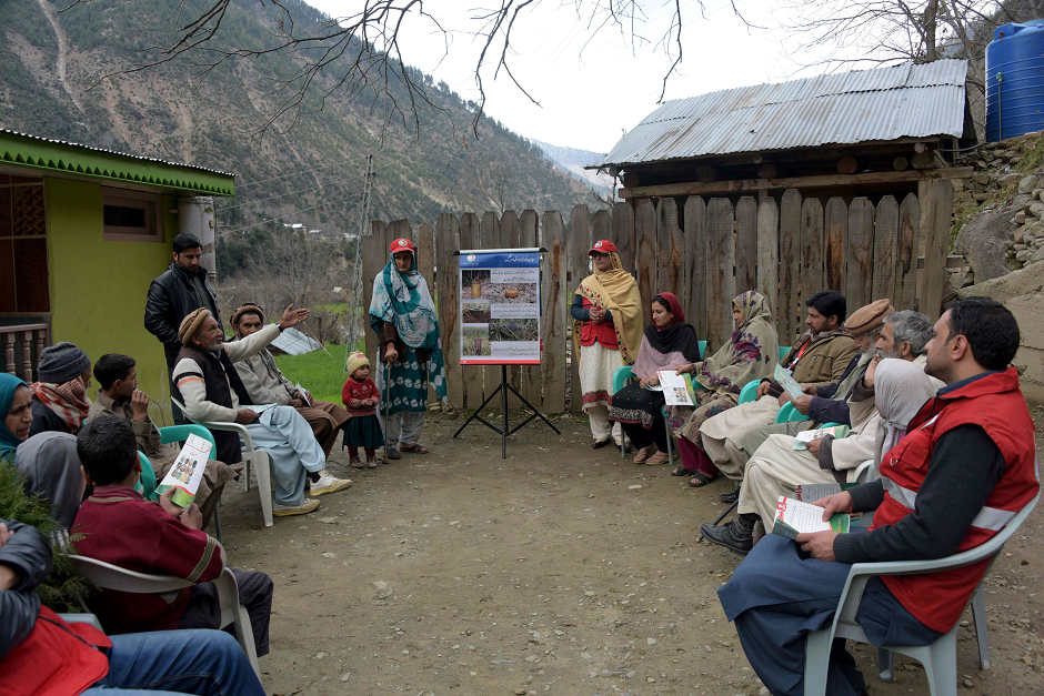 This picture shows an official of the Pakistan Red Crescent Society (PRCS) leading an awareness campaign for landmines to local residents in Abbaspur. PHOTO: AFP.