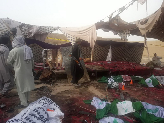 Pakistani Frontier Constabulary (FC) personnel stand at the bomb blast site in Mastung. PHOTO:AFP