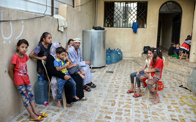 Despite the Islamic State group being driven from Mosul, 61-year-old Sana Ibrahim faces daily hardship in looking after her 22 grandchildren and her Alzheimer's-ridden septuagenarian husband. PHOTO:AFP