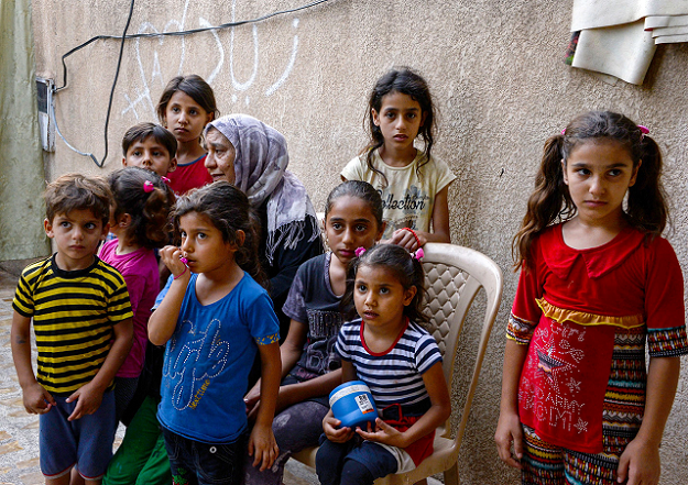 Sana Ibrahim sits with her family in a courtyard in their home in the northern city of Mosul. PHOTO:AFP